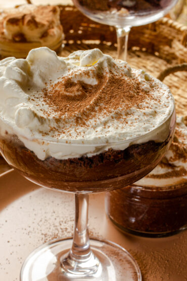Clear cocktail class with dark chocolate mousse and whipped cream.